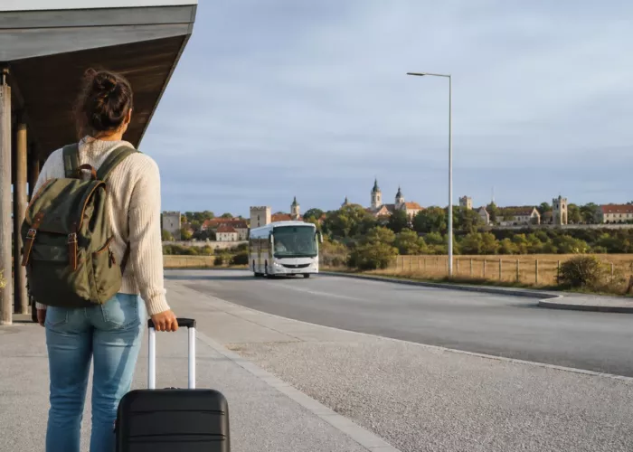 Budget traveller waiting for ground transport from Visby Airport toward Visby